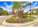 Welcome to West Lake: A beautifully landscaped community entrance with colorful flowers and signage at 11521 Crowned Sparrow Ln, Tampa, FL 33626
