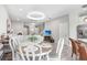 Open dining area with a modern light fixture, breakfast bar, and seamless flow to the living area at 11521 Crowned Sparrow Ln, Tampa, FL 33626