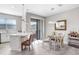 Bright dining area with a modern light fixture, white dining set, and breakfast bar at 11521 Crowned Sparrow Ln, Tampa, FL 33626