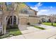 Townhouse exterior with manicured lawn, neutral paint, covered entrance and two-car garage at 11521 Crowned Sparrow Ln, Tampa, FL 33626