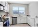 Well-lit kitchen with stainless steel appliances, white cabinets, and pristine countertops at 11521 Crowned Sparrow Ln, Tampa, FL 33626
