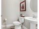 Charming powder room with stylish pedestal sink, decorative art, and unique accessories at 11521 Crowned Sparrow Ln, Tampa, FL 33626