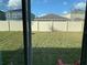 Fenced-in backyard with a grassy lawn, providing a private outdoor space at 11624 Fringetree Ct, Riverview, FL 33579