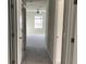Hallway view showcasing a neutral-toned carpet and window for natural light at 11624 Fringetree Ct, Riverview, FL 33579