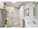 Bathroom featuring shower-tub combo, cabinets, sink, mirror and decorative accents at 12501 Ulmerton Rd # 133, Largo, FL 33774
