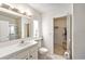Bathroom features white cabinets, tile floors, walk-in closet, toilet and sink at 12501 Ulmerton Rd # 133, Largo, FL 33774
