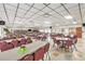 Spacious community center room with tables, chairs, and a library in the background providing an inviting space for residents at 12501 Ulmerton Rd # 133, Largo, FL 33774