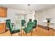 Dining room features a glass-top table with green velvet chairs and modern lighting at 12501 Ulmerton Rd # 133, Largo, FL 33774