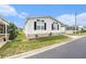 Charming white home with manicured lawn, brick foundation and inviting curb appeal at 12501 Ulmerton Rd # 133, Largo, FL 33774