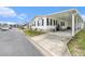 Well-maintained home with landscaping, white exterior, and convenient parking at 12501 Ulmerton Rd # 133, Largo, FL 33774