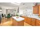 Open-concept kitchen featuring an island, stainless steel appliances, and wood flooring at 12501 Ulmerton Rd # 133, Largo, FL 33774