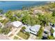 Aerial view showcasing the property, its landscaping, and proximity to the water at 126 Orangewood Dr, Dunedin, FL 34698