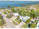Stunning aerial view showcasing the property's prime waterfront location and meticulously landscaped grounds at 126 Orangewood Dr, Dunedin, FL 34698