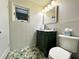 Bathroom with green vanity and stylish patterned floor tiles at 126 Orangewood Dr, Dunedin, FL 34698