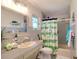 bathroom featuring a tub, shower, and cheerful decor at 126 Orangewood Dr, Dunedin, FL 34698
