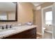 Bathroom featuring a granite countertop, dark wood cabinets, and a separate toilet room at 126 Orangewood Dr, Dunedin, FL 34698