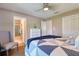Bedroom with neutral walls, hardwood floors, closet, and a view of the adjoining bathroom at 126 Orangewood Dr, Dunedin, FL 34698