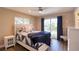 Bedroom featuring a ceiling fan, wood floors, and sliding glass door to outdoor deck at 126 Orangewood Dr, Dunedin, FL 34698