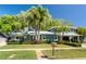 Charming home with mature landscaping and a spacious covered carport nestled among mature trees at 126 Orangewood Dr, Dunedin, FL 34698