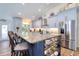 A bright kitchen features a large island with marble countertop, stainless appliances and seating at 126 Orangewood Dr, Dunedin, FL 34698