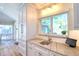 Well-lit kitchen area with stylish countertops, white cabinetry, and a modern faucet at 126 Orangewood Dr, Dunedin, FL 34698