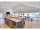 Spacious open-concept kitchen with an island, stainless appliances, dining area, and ample natural light at 126 Orangewood Dr, Dunedin, FL 34698