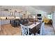 Open-concept kitchen flowing into a dining and living area, with modern appliances and stylish decor at 126 Orangewood Dr, Dunedin, FL 34698