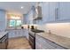 This spacious kitchen features custom cabinets, stainless appliances, and a beautiful granite countertop at 126 Orangewood Dr, Dunedin, FL 34698