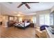 Spacious main bedroom featuring ceiling fans, wood floors, and multiple windows with plantation shutters at 126 Orangewood Dr, Dunedin, FL 34698