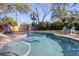 Relaxing backyard pool with lush landscaping, wooden shed and ample space for lounging and enjoying the Florida sunshine at 126 Orangewood Dr, Dunedin, FL 34698