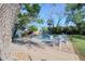 Backyard featuring an in-ground pool, lounge chairs, and lush landscaping at 126 Orangewood Dr, Dunedin, FL 34698