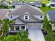 Aerial view of a well-maintained home with lush landscaping and a spacious driveway at 13113 Rain Lily Dr, Riverview, FL 33579