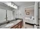 Bathroom features a double sink vanity with dark wood cabinets and granite counters at 13113 Rain Lily Dr, Riverview, FL 33579