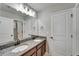 Bathroom features a double sink vanity with dark wood cabinets and granite counters at 13113 Rain Lily Dr, Riverview, FL 33579