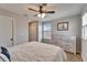 Comfortable bedroom with light gray walls, ceiling fan and window offering plenty of natural light at 13113 Rain Lily Dr, Riverview, FL 33579