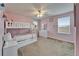 Pink bedroom with a bunk bed, large windows, and white dresser at 13113 Rain Lily Dr, Riverview, FL 33579