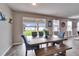 Dining room boasts backyard view with a farmhouse table and bench seating for relaxed meals at 13113 Rain Lily Dr, Riverview, FL 33579