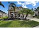 Charming two-story home features stone accents and well-maintained landscaping with palm trees at 13113 Rain Lily Dr, Riverview, FL 33579