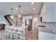 Kitchen with central island, pendant lighting, and a view of the staircase at 13113 Rain Lily Dr, Riverview, FL 33579