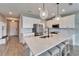 Bright kitchen with large center island, stainless appliances, and pendant lighting at 13113 Rain Lily Dr, Riverview, FL 33579
