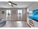 Bright and airy living room with a media center and view of the landscaped front yard at 13113 Rain Lily Dr, Riverview, FL 33579