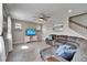 Comfortable living room with a large sectional, ceiling fan, and media center, perfect for relaxing at 13113 Rain Lily Dr, Riverview, FL 33579