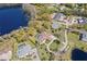 Stunning aerial perspective of a luxury home with a pool, situated on a picturesque waterfront property amidst nature at 16119 Carencia Ln, Odessa, FL 33556