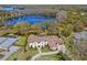 Beautiful aerial view of a large, luxurious home with a manicured lawn, mature trees, and landscaping at 16119 Carencia Ln, Odessa, FL 33556