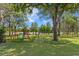 Large backyard area with playground, fenced-in area, beautiful lawn and backing onto a lake at 16119 Carencia Ln, Odessa, FL 33556