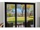 View from inside overlooking a beautiful backyard featuring a playground and a serene lake at 16119 Carencia Ln, Odessa, FL 33556