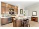 Wet bar featuring custom cabinetry, granite countertops, and a wine refrigerator at 16119 Carencia Ln, Odessa, FL 33556