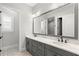 Elegant bathroom features a double vanity with marble countertops and stylish patterned tile flooring at 16119 Carencia Ln, Odessa, FL 33556