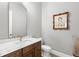 Powder room with marble countertop, wood cabinet, decorative painting, and elegant wall paper at 16119 Carencia Ln, Odessa, FL 33556