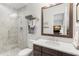 Modern bathroom featuring a walk-in shower with herringbone tiles, stylish vanity, and a large mirror at 16119 Carencia Ln, Odessa, FL 33556